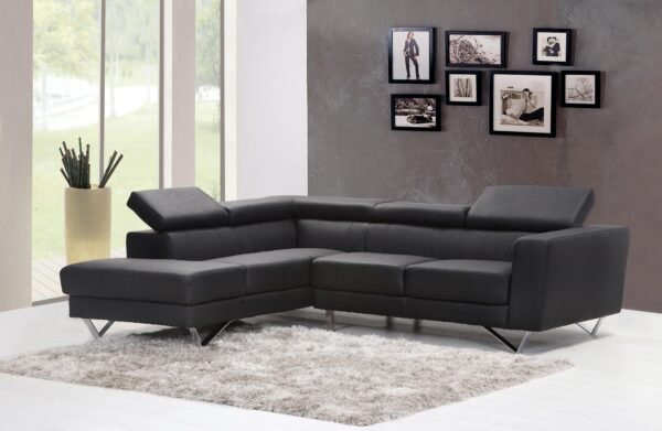 Contemporary living room featuring a sleek black sectional sofa and chic wall art.